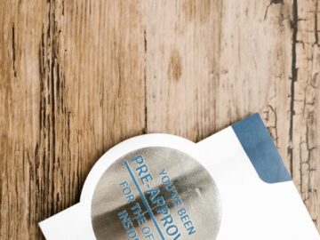 A pre-approved offer envelope with a sticker lies on a rustic wooden surface.