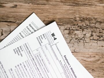 Detailed shot of tax forms on a wooden surface, ideal for concept themes like finance and documentation.
