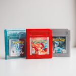 Close-up photo of classic Pokemon game cartridges in a studio setting.