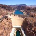 A breathtaking aerial shot of the Hoover Dam under a clear blue sky.