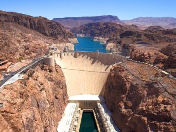 A breathtaking aerial shot of the Hoover Dam under a clear blue sky.
