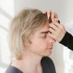 Close-up of a man enjoying acupuncture therapy for holistic health and wellness.