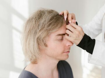 Close-up of a man enjoying acupuncture therapy for holistic health and wellness.
