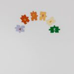 Colorful puzzle pieces spelling 'autism' on a white background symbolizing autism awareness.