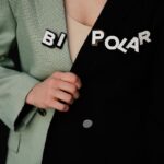 Close-up of a unique two-tone blazer with 'BI POLAR' text highlighting fashion concepts.