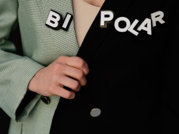 Close-up of a unique two-tone blazer with 'BI POLAR' text highlighting fashion concepts.