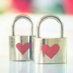 Two silver padlocks with heart symbols, representing love and romance.