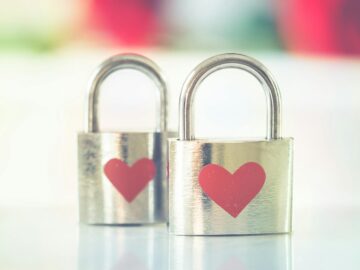 Two silver padlocks with heart symbols, representing love and romance.