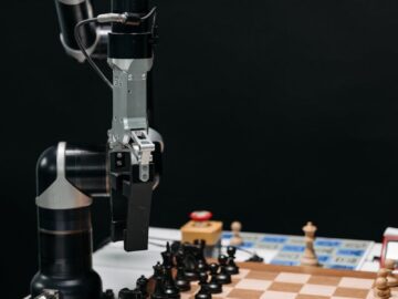 Robotic arm making a strategic move on a chessboard, showcasing AI in games.
