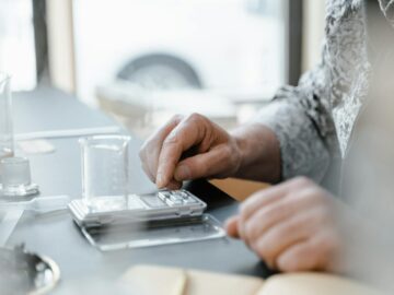 A hand uses a digital scale with a beaker in a laboratory setting. Perfect for scientific and educational content.