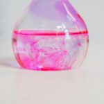 Close-up of pink dye diffusing in a laboratory flask, perfect for science and chemistry themes.