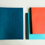 A flatlay of vibrant notebooks on a white surface. Ideal for stationery and education themes.