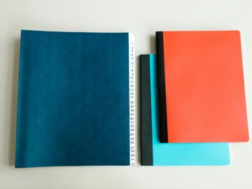 A flatlay of vibrant notebooks on a white surface. Ideal for stationery and education themes.