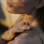 Close-up portrait showcasing the natural beauty and diversity of skin with vitiligo in warm, artistic light.