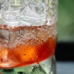 Chilled drink with ice cubes and bubbles, perfect for refreshment.