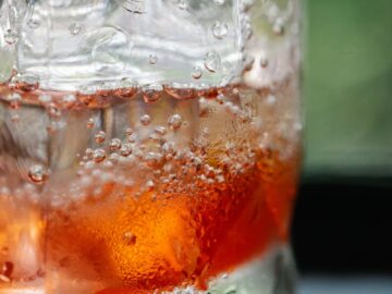 Chilled drink with ice cubes and bubbles, perfect for refreshment.
