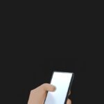 3D illustration featuring a hand holding a smartphone on a black background.