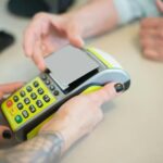 Hands engaging in a secure card transaction with a payment terminal, capturing the essence of modern business transactions.