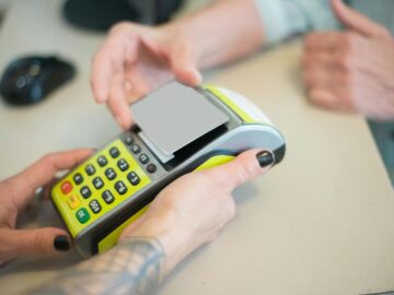 Hands engaging in a secure card transaction with a payment terminal, capturing the essence of modern business transactions.