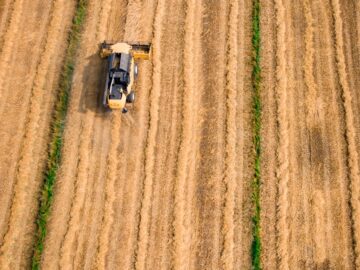 aerial photography of yellow cultivator on brown field