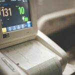 Close-up shot of a medical ECG monitor displaying heart rate and oxygen levels, essential for patient monitoring.
