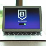 MacBook Air displaying a blockchain concept screen in a bright indoor setting.