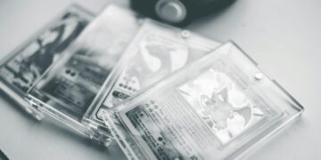Close-up of collectible Pokemon cards in protective cases, emphasizing preservation and value.