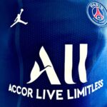 Detailed view of Paris Saint-Germain jersey with sponsor logos and design elements.