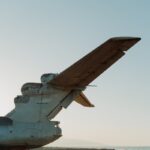 A Soviet-era ekranoplan tail on a deserted Dagestan beach, highlighting military history.