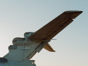 A Soviet-era ekranoplan tail on a deserted Dagestan beach, highlighting military history.
