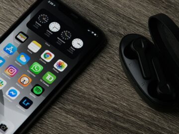 black iphone 5 on brown wooden table