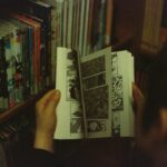person holding white and black book