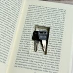 An open book with a pair of scissors sticking out of it