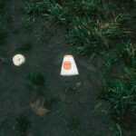 an orange and white frisbee laying on the ground