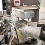 a woman working on a machine in a factory