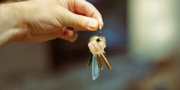 A person holding a bunch of keys in their hand