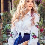 woman in white dress shirt holding book