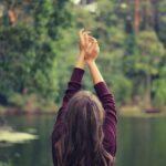 woman raising both of her hands