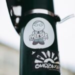 black and white bicycle with brown strap