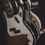 brown and black bass guitars