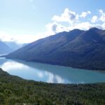 lake in the middle of mountains during daytime