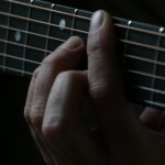 person using guitar