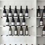 wine bottle on white wooden shelf