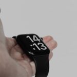 a person holding a smart watch in their hand