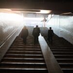 three man walking on stair