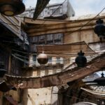 a narrow alley with lots of hanging objects