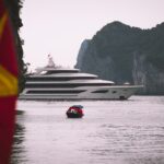 white yacht near islet during daytime