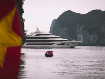 white yacht near islet during daytime