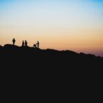 silhouette of people on a mountain
