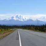 a road with a mountain in the background
